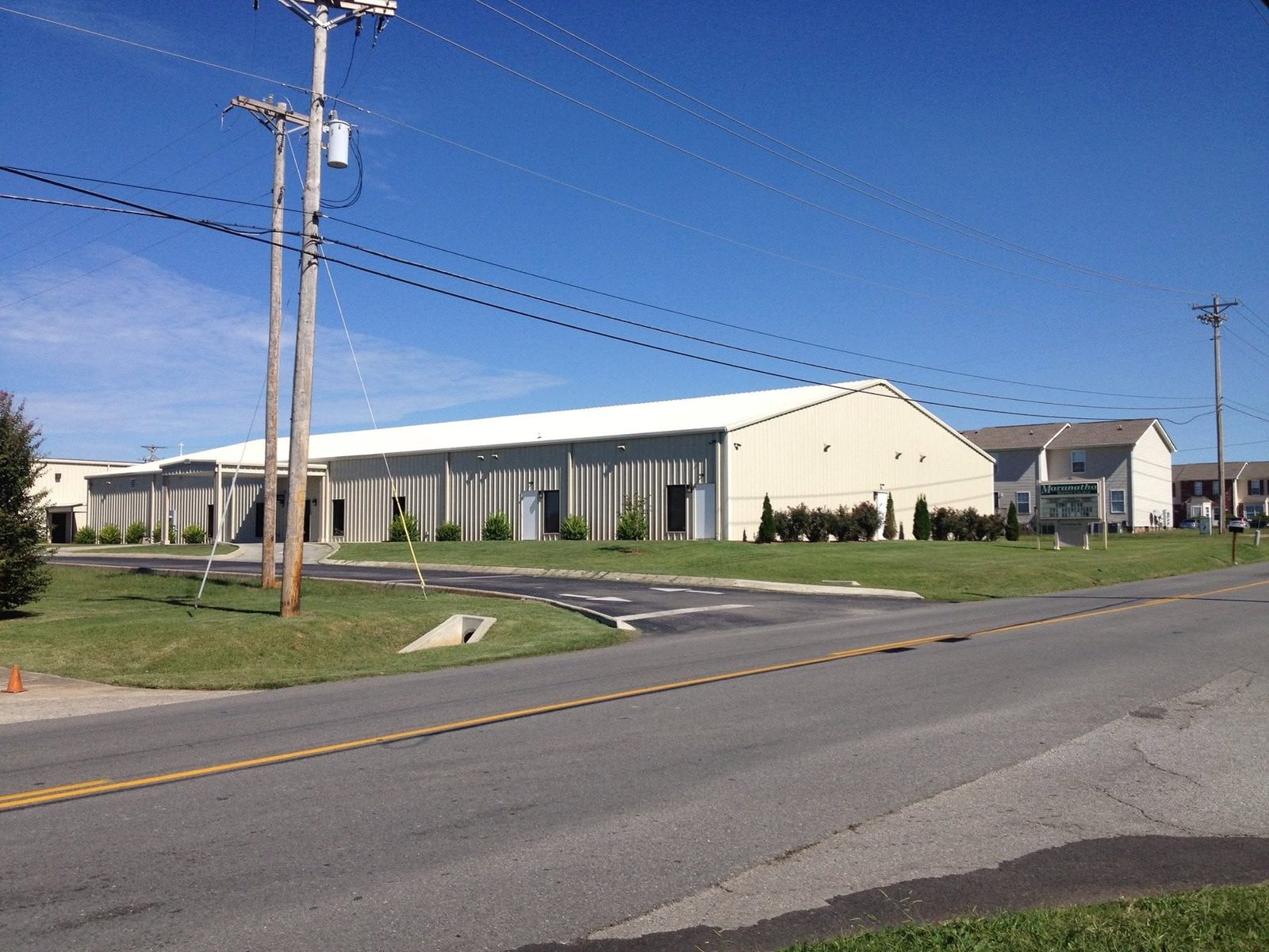Interior warehouse with red iron frames, mezzanine, and storefront endwall