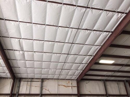 Finished high-R ceiling — white facing quilted in each bay