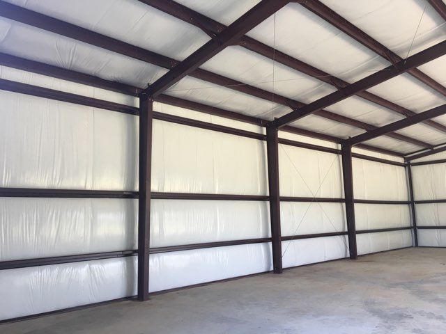 White vinyl-reinforced facing on walls and roof, Z-girts exposed